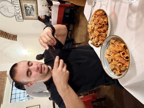 Team member photographing pasta at a restaurant